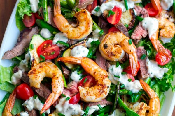 Surf & Turf Salad - Made with grilled steak, shrimp and creamy garlic dressing. This steak salad recipe is paleo, Whole30, gluten-free and keto friendly. #surfturf #salad #steak #prawns #shrimp #whole30 #paleo #keto #glutenfree