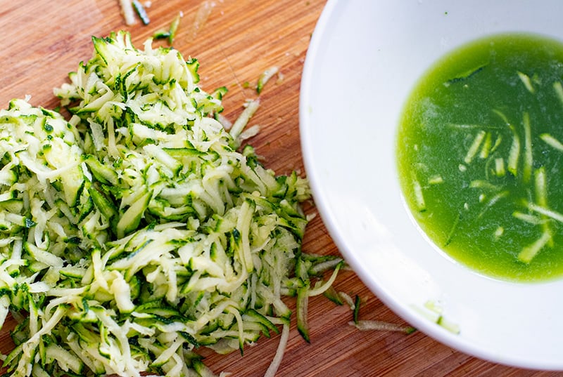 Squeezing shredded zucchini for juice