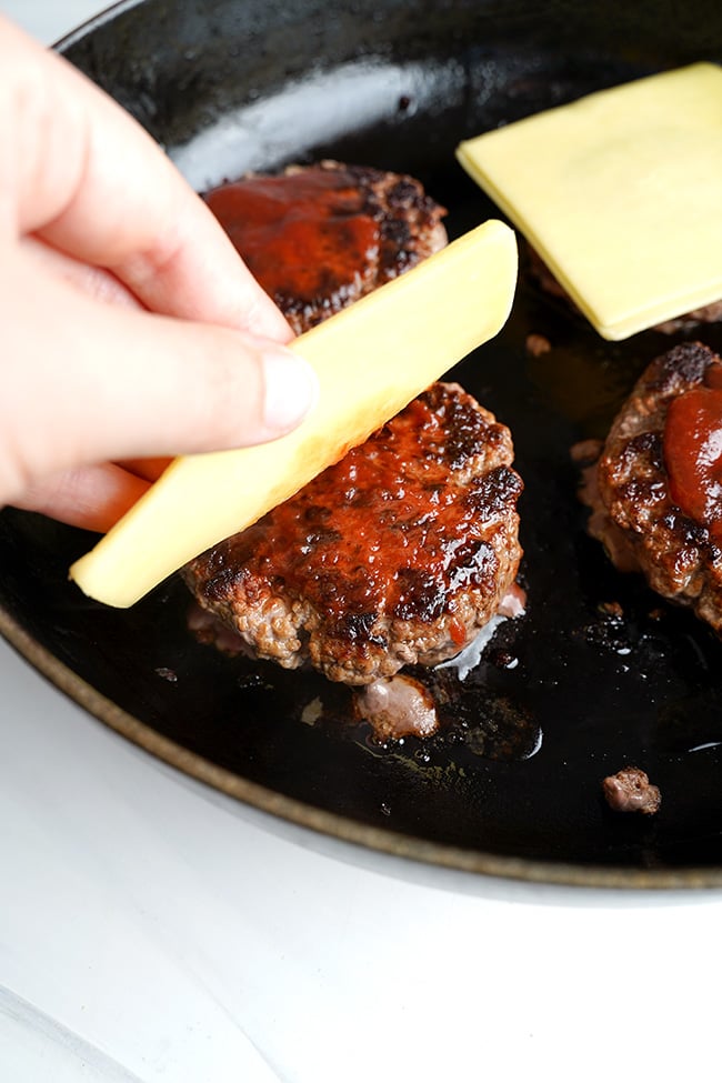 Cheese melted over hamburger patties