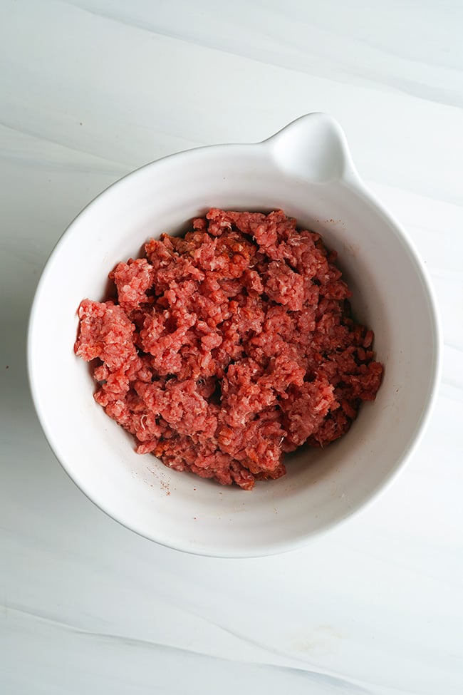 Ground beef hamburgers mixture in a bowl