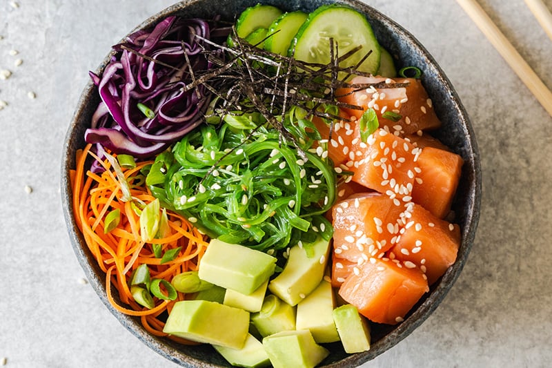 How to make a poke bowl - featuring salmon, avocado, wakame seaweed and vegetables